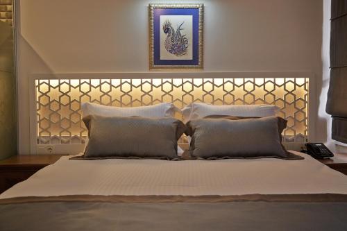 a bedroom with a large bed with two pillows at Arart Hotel in Istanbul