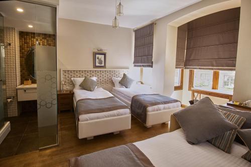 a hotel room with two beds and a bathroom at Arart Hotel in Istanbul