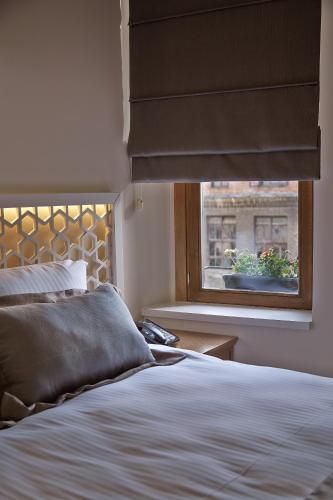 a bedroom with a bed and a window with a blind at Arart Hotel in Istanbul