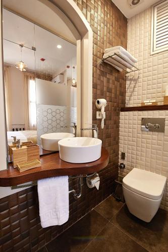 a bathroom with a sink and a toilet and a mirror at Arart Hotel in Istanbul