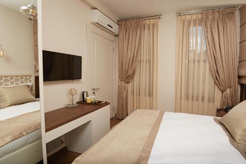 a hotel room with two beds and a television at Arart Hotel in Istanbul