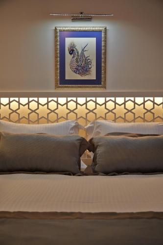 a bedroom with a bed with a picture on the wall at Arart Hotel in Istanbul