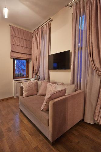 a living room with a couch and a flat screen tv at Arart Hotel in Istanbul