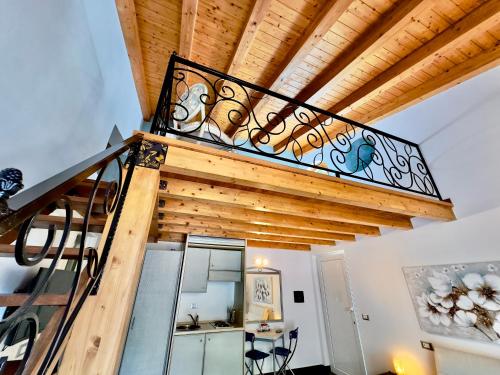 a staircase in a house with a wooden ceiling at Cinqueterre Residence in Riomaggiore