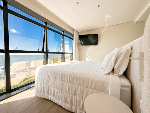Giường trong phòng chung tại Blue Sea Hotel Suite Luxo Frente Mar