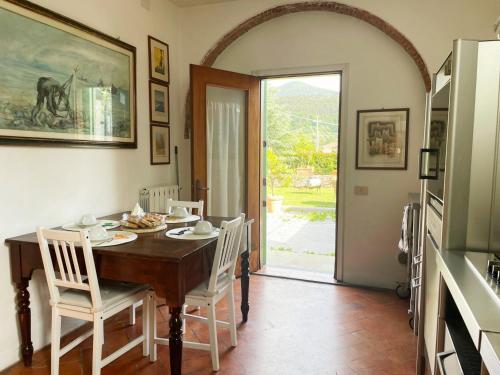 a dining room with a wooden table and chairs at 'Il Casale di Giova' Tuscan Farmhouse in Lucca