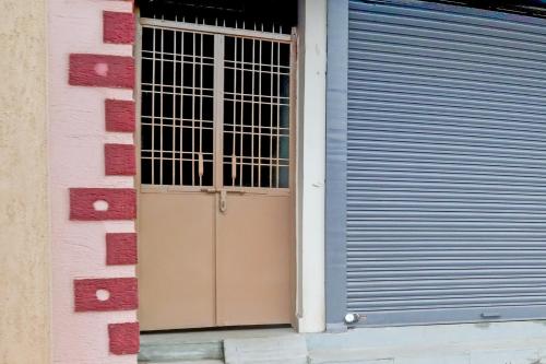 a door in a building with a gate at Hotel O IMPERIAL in Jabalpur