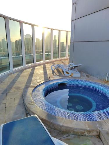 a swimming pool on the side of a building at Cozy Studio Apartment in Dubai