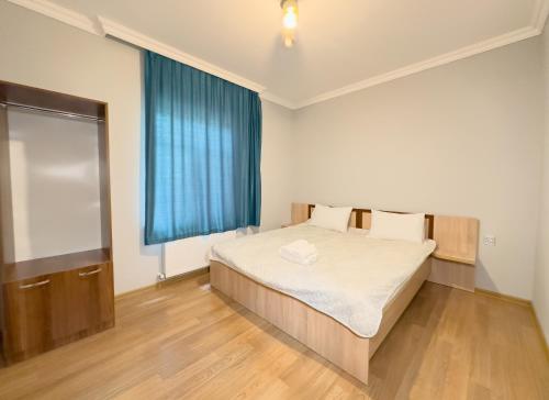 a bedroom with a bed and a blue window at River Garden Gabala -Rooms , Villas in Gabala