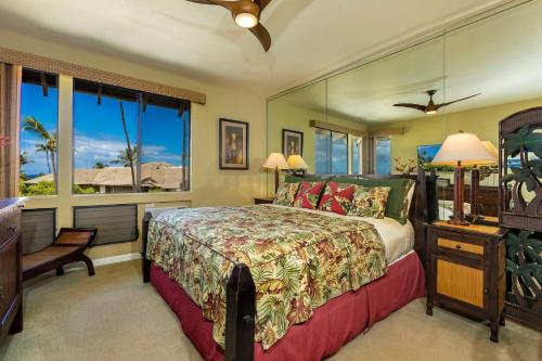 a bedroom with a bed and a window at Grand Champions 60 by Coldwell Banker Island Vacations in Wailea