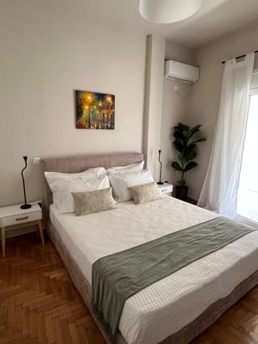 a bedroom with a large bed with white pillows at KK Athens Fine Stay-Steps to Metro-Modern & Cozy Apartments in Athens