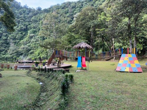 a park with a playground with tables at Telaga Warna in Tengahgirang