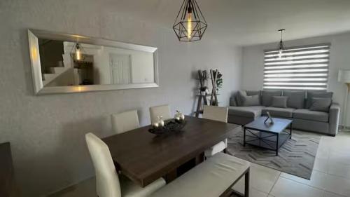 a living room with a table and a couch at VALQUIRICO y VW A POCOS MINUTOS in Santa María Coronanco