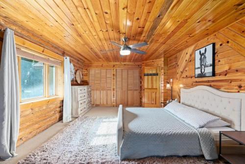 a bedroom with a bed and a wooden ceiling at Private Island Fire Pit & Arcade in Rigby