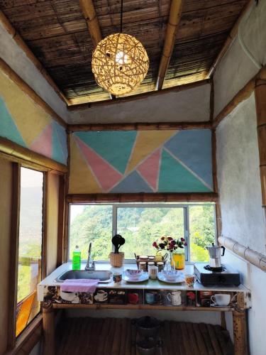 a kitchen with a sink in a room with a window at RIYA Tesoro de la montaña Cabaña Armonia in Ibagué