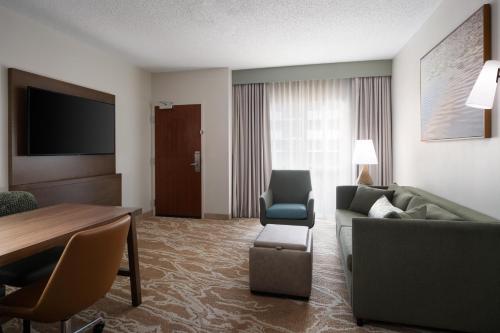 a living room with a couch and a table at Embassy Suites San Marcos Hotel Conference Center in San Marcos