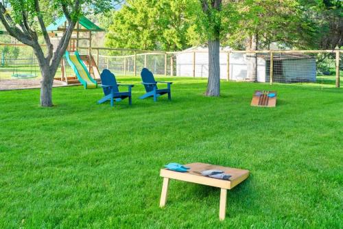 two chairs and a table in a yard with a playground at Downtown Lava - Views Huge Yard Slide Games in Lava Hot Springs