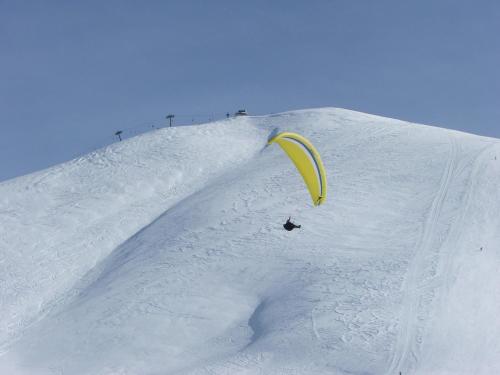 a person in the snow with a kite on a snow ramp at Aloni Toy Kir Thanasi Hotel & Spa in Volakas