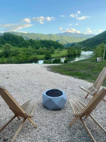 two chairs and a fire pit on top of a hill at Bungalov La Repit in Šipovo