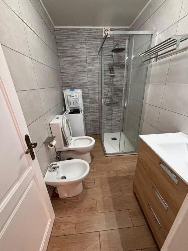 a bathroom with a toilet and a sink and a shower at Beach Apartment with Ocean View La Arena in Puerto de Santiago
