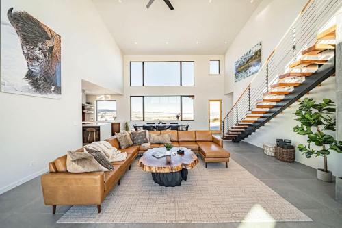 a living room with a couch and a table at Luxury Retreat Epic Views & Hot Tub in Tetonia