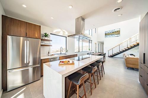 a kitchen with a large island with bar stools at Luxury Retreat Epic Views & Hot Tub in Tetonia