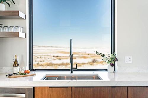 a kitchen with a sink and a large window at Luxury Retreat Epic Views & Hot Tub in Tetonia