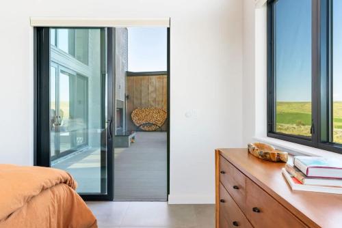 a bedroom with a glass door leading to a balcony at Luxury Retreat Epic Views & Hot Tub in Tetonia