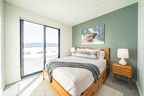 a bedroom with a bed and a large window at Luxury Retreat Epic Views & Hot Tub in Tetonia