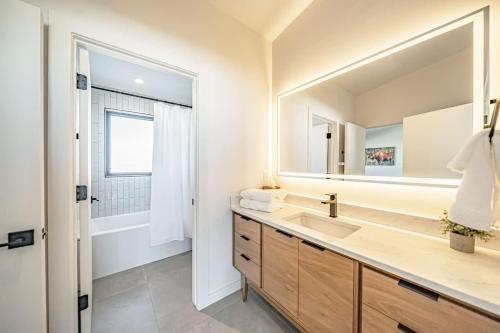 a bathroom with a sink and a large mirror at Luxury Retreat Epic Views & Hot Tub in Tetonia