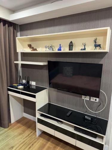 a large entertainment center with a large flat screen tv at Dusit Grand Park 1 in Jomtien Beach
