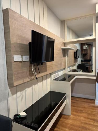 a living room with a flat screen tv on a wall at Dusit Grand Park 1 in Jomtien Beach