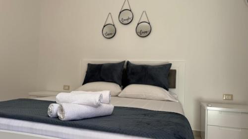 a bedroom with a bed with three mirrors on the wall at Amel's Apartments Comfortable Family Stay Near Orikum Beach in Orikum