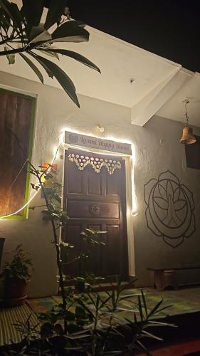 a room with a door with a sign on the wall at Laxmi Happy Home in Querim Goa in Querim