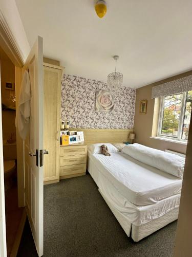 a bedroom with two beds and a window at Station Approach B&B Boutique Stays in Solihull