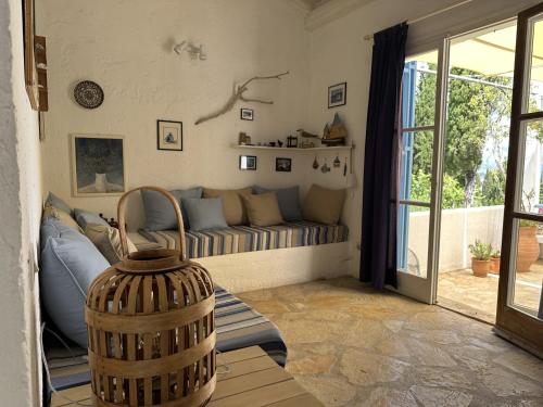 a living room with a couch and a window at Sea View Apartment in the Greek Nature in Gouvia