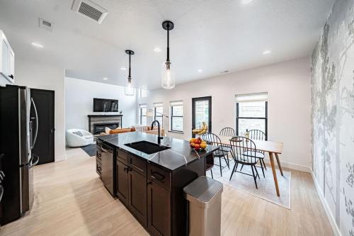 a kitchen and dining room with a black and white kitchen at Unique Townhome with AC Garage Patio in Driggs