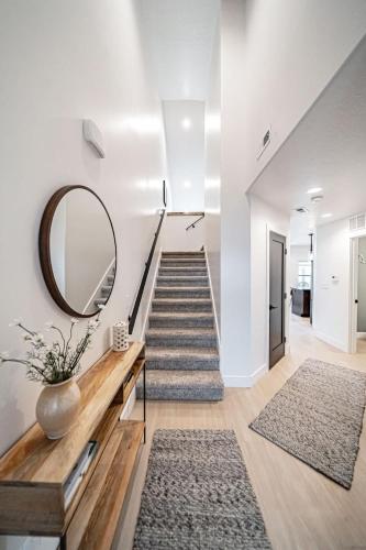a stairwell with a mirror and a staircase with rugs at Unique Townhome with AC Garage Patio in Driggs