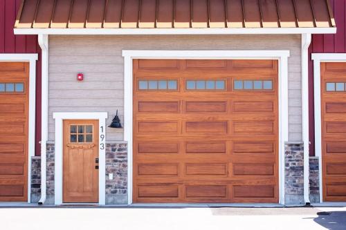 a pair of wooden garage doors on a house at Mtn Views Patio & South Fork Fun in Swan Valley