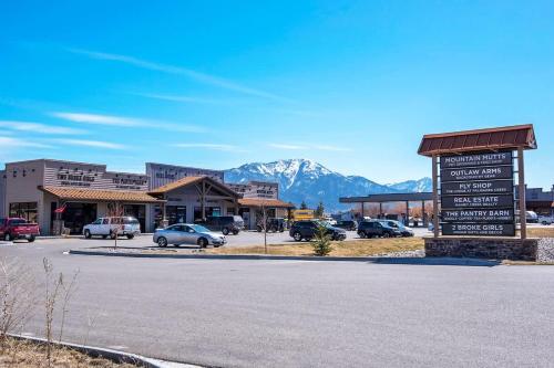 a sign in front of a parking lot with a mountain at Mtn Views Patio & South Fork Fun in Swan Valley