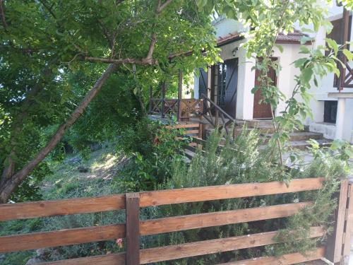 a wooden fence in front of a house at Mountain and Sea view in Miléai