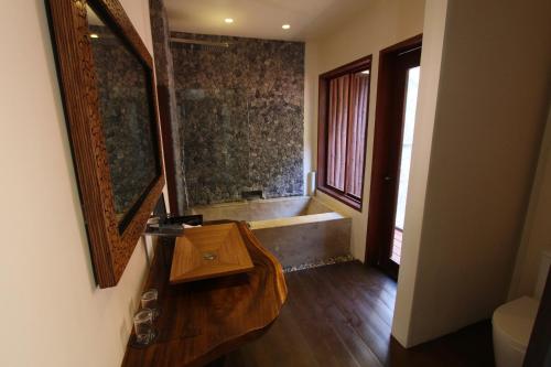 a bathroom with a sink and a bath tub at Cauayan Island Resort and Spa in El Nido