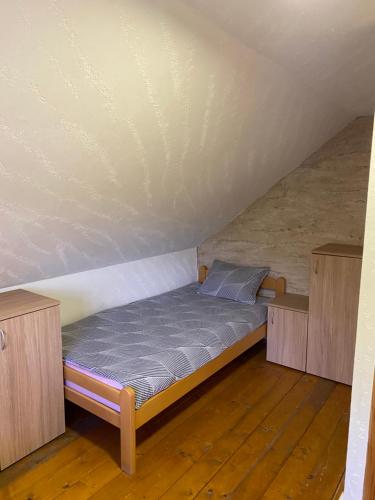 a small bed in a room with a attic at Aphrodite Hills Apartments-Stara Planina in Crni Vrh