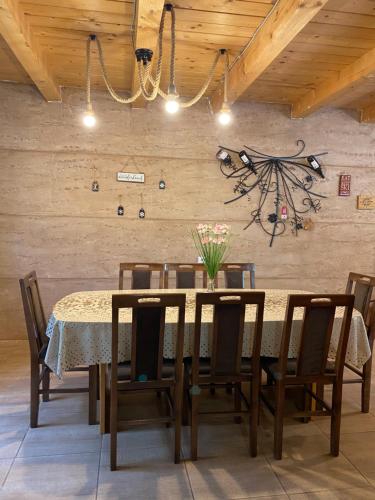 a dining room with a table with chairs and a chandelier at Aphrodite Hills Apartments-Stara Planina in Crni Vrh