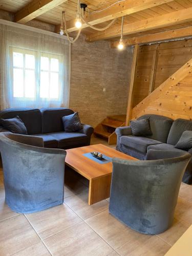 a living room with couches and a coffee table at Aphrodite Hills Apartments-Stara Planina in Crni Vrh