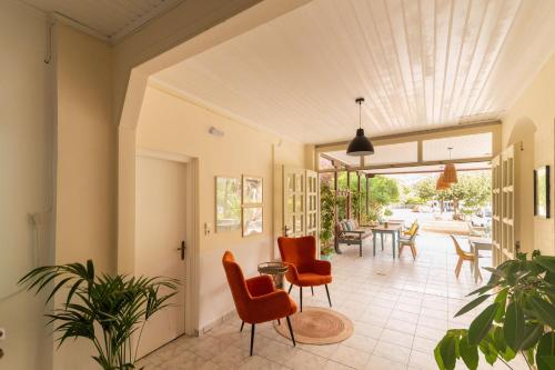 an open hallway with chairs and a table at Pension Romantika in Matala