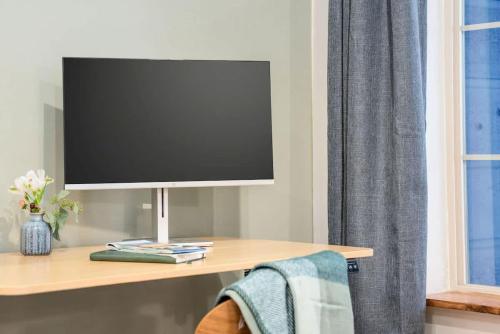 a tv sitting on a desk with a tv on it at Stylish Mtn Home Fireplace Views in Victor