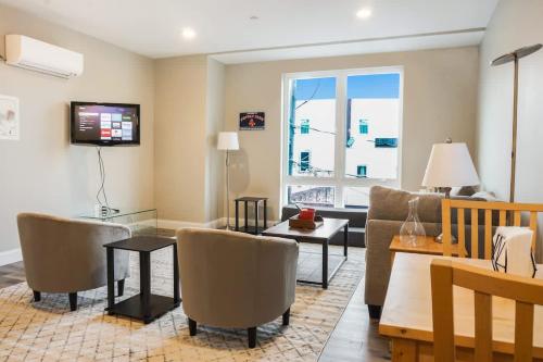 a living room with a couch and a table at Unit 22 Luxurious 1BR Apartment Long-term stays in Chelsea