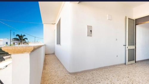 a white apartment with a view of the ocean at Aura apartaments in Torre Lapillo
