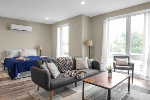 a living room with a couch and a bed at 46 Bright and Sunny Studio Long-term stays in Chelsea